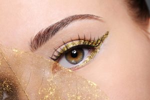 macro-shot-beauty-female-eye-with-golden-eyeliner-make-up-covered-artificial-yellow-leaf macro-shot-beauty-female-eye-with-golden-eyeliner-make-up-covered-artificial-yellow-leaf